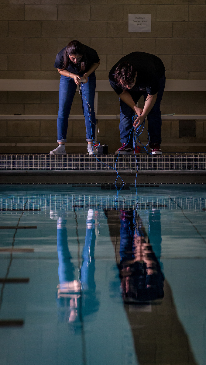 Team members concentrate on their robot maneuvers.