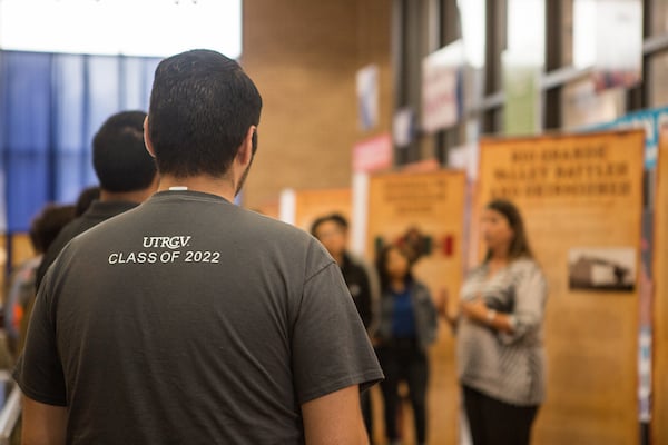 Guests listen to a presentation at the exhibit