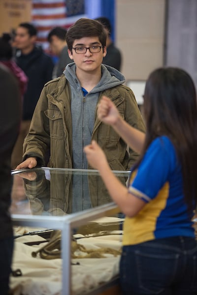 Student listens to a presentation from the exhibit