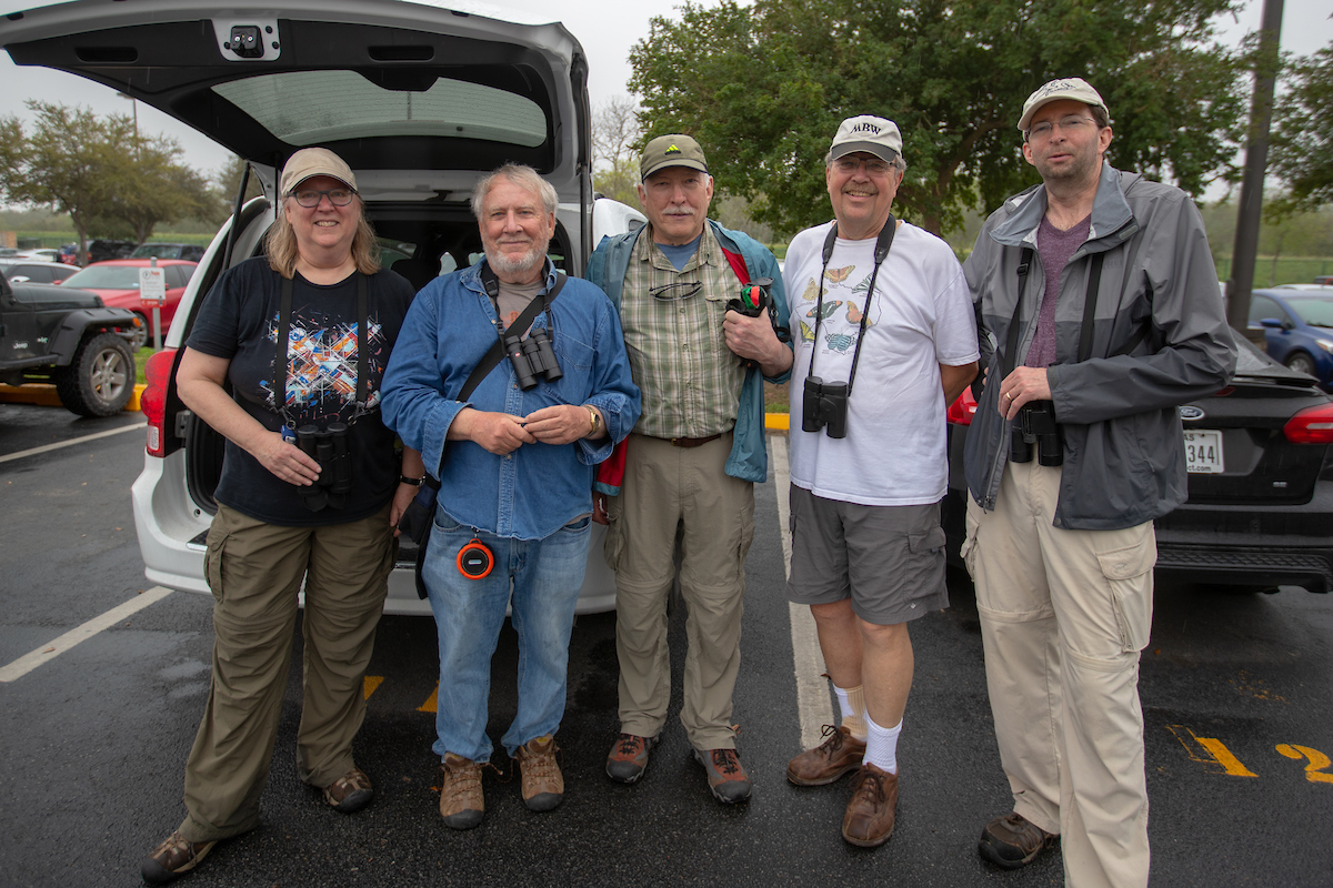 5 birders from Minnesota pose by their car in the UTRGV Brownsville parking lot