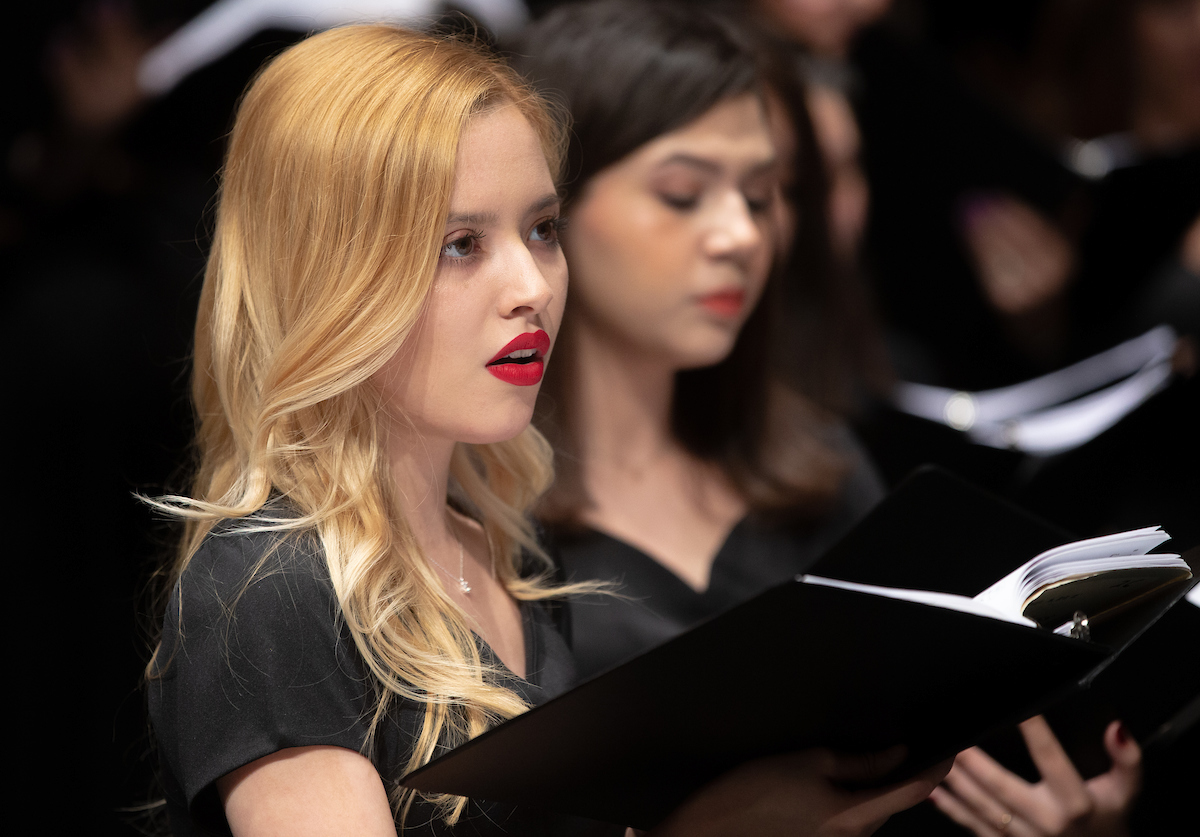 woman sings during performance