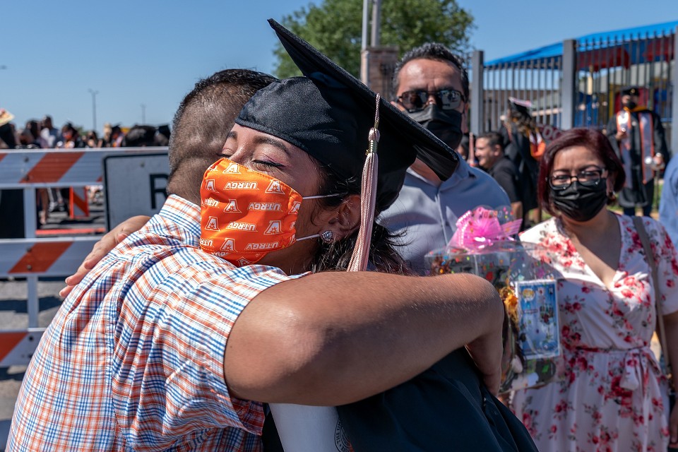 family member and graduate hugging