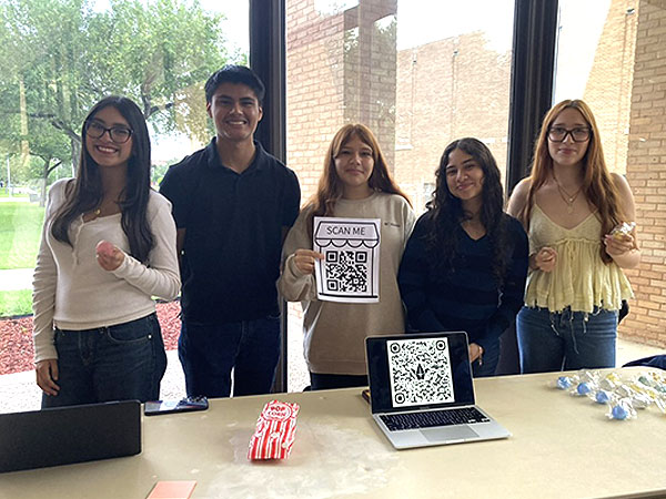 NovaRhet 2026   Students standing by table display at NovaRhet 2026