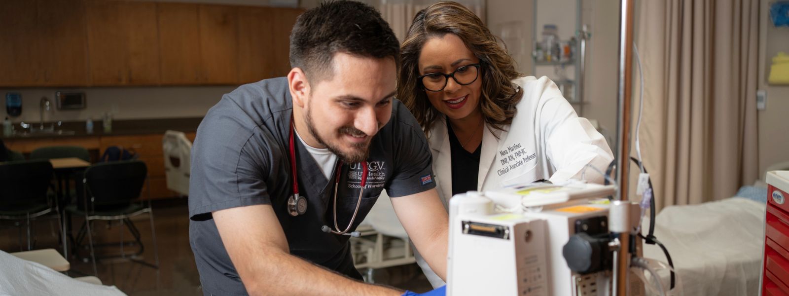 Nursing student assisting patient with faculty in hospital-like setting.