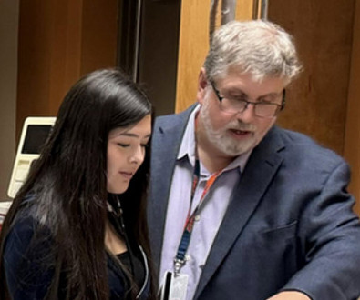 Faculty assisting student with assignment.