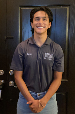 Student posing for photo while smiling.