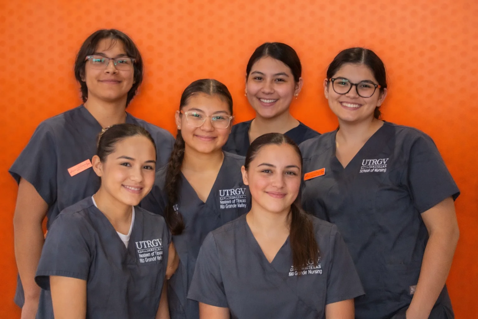 students in scrubs smiling 
