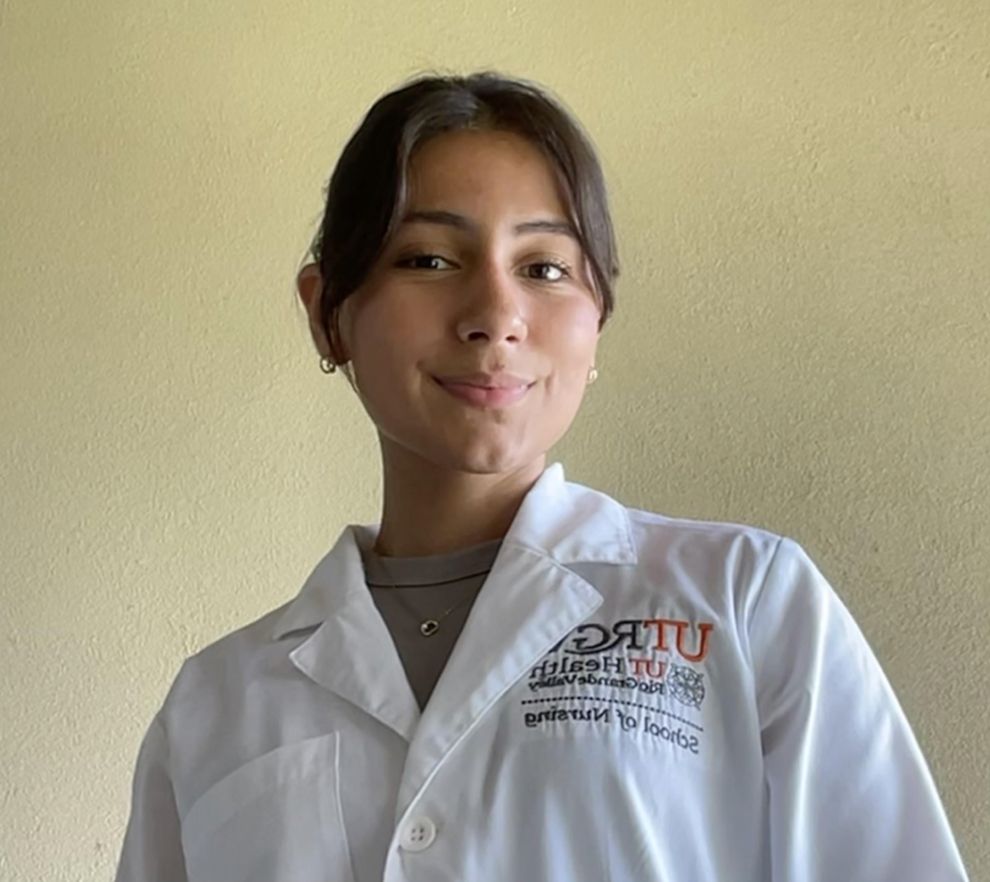 Smiling, student portrait wearing white coat.