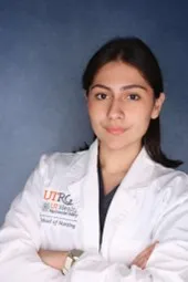 Smiling, student portrait wearing white coat.