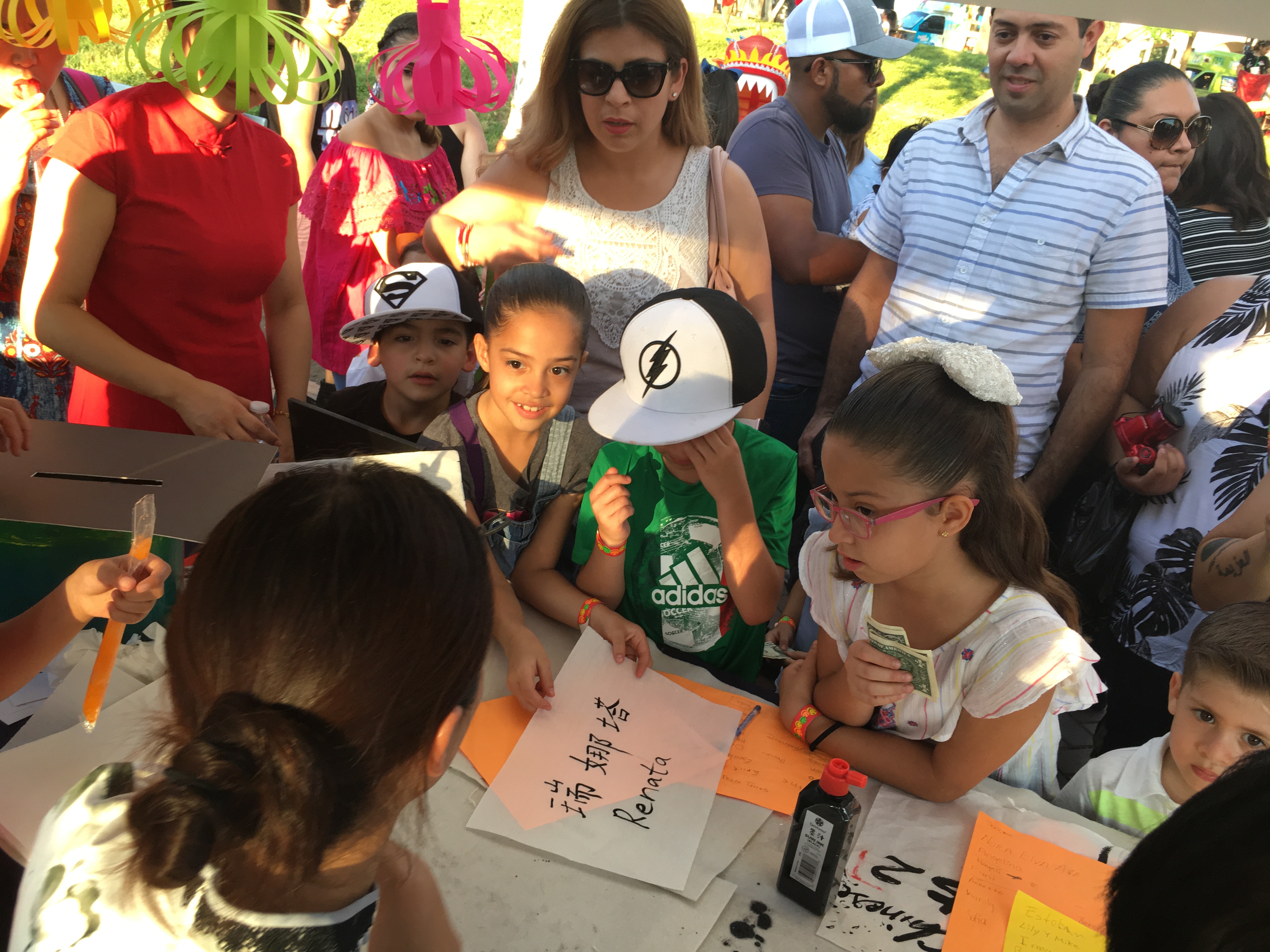 Children interacting with teachers at Fiesta de Palmas in McAllen