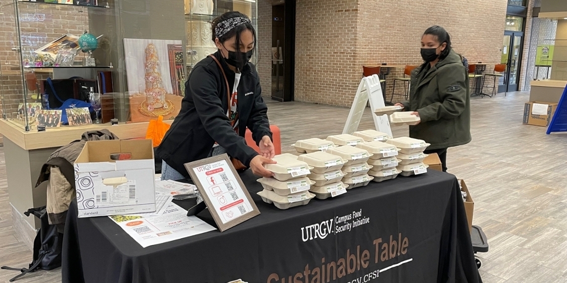 Student preparing food plates to give to the public Page Banner 