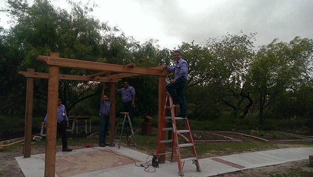 The facilities crew put the finishing touches on the pergola. Phtoto: LCarreon