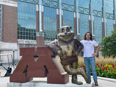 A student poses next to the Goldy Gopher statue near the student union at the University of Minnesota