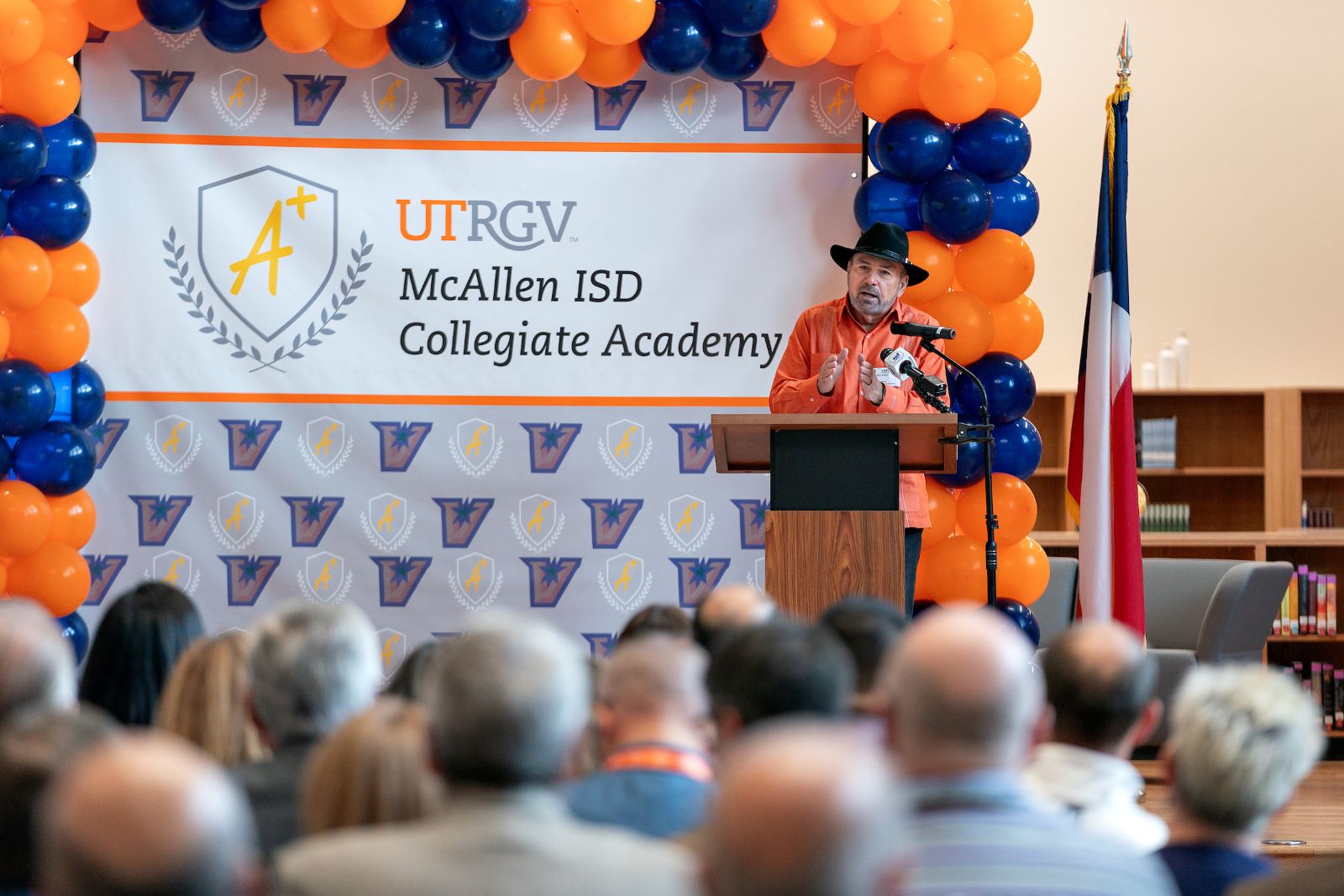 President Bailey speaks in front of stage.