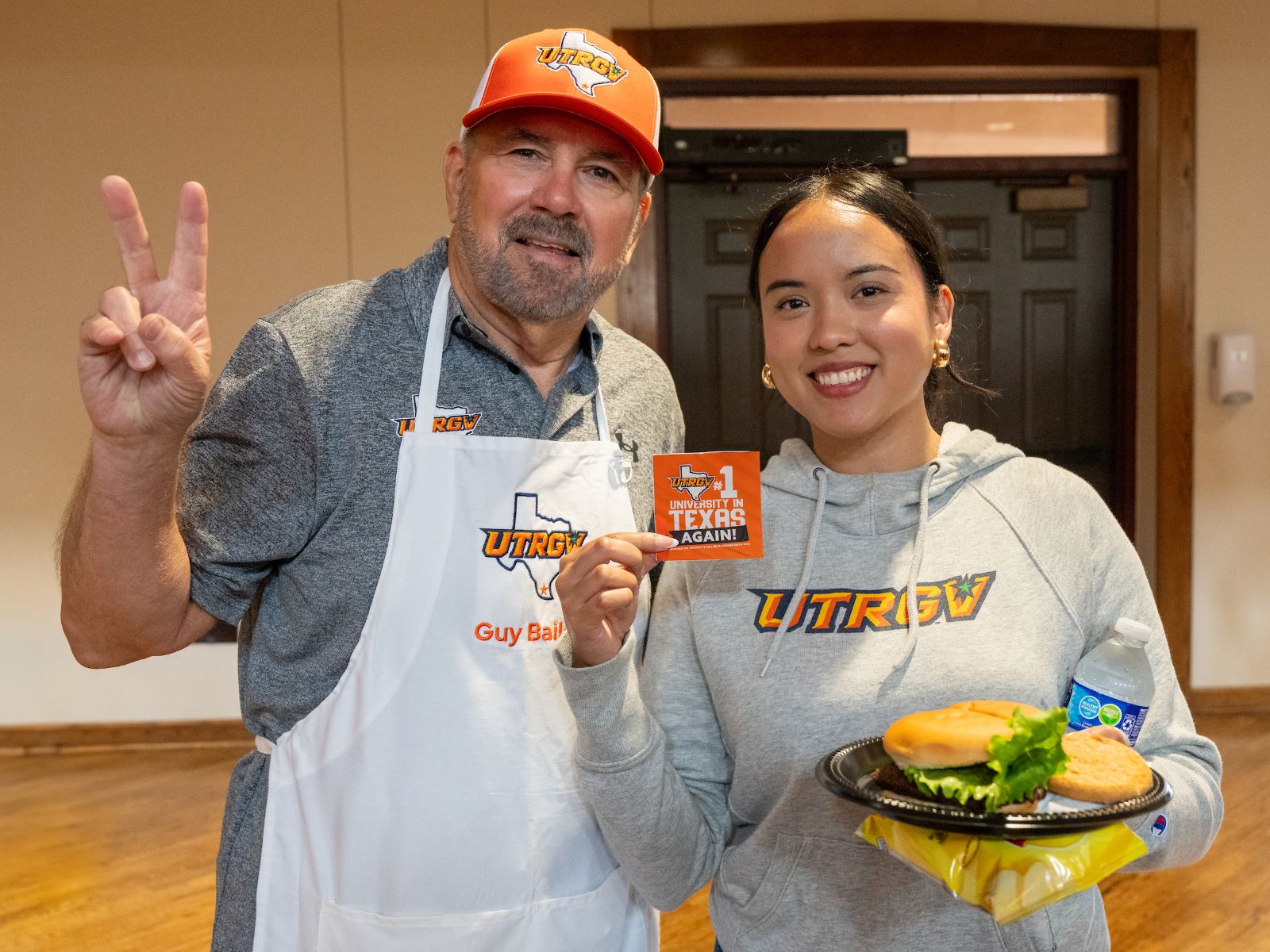 President Bailey posing with V's up with a university employee.