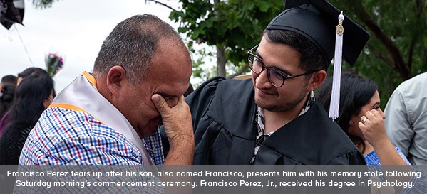 Francisco Perez tears up after his son, also named Francisco, presents him with his memory stole following Saturday morning's commencement ceremony. Francisco Perez, Jr. received his degree in Psychology.