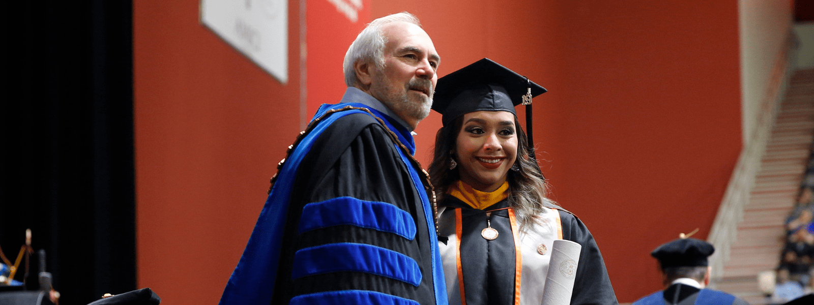 President Bailey with graduate.