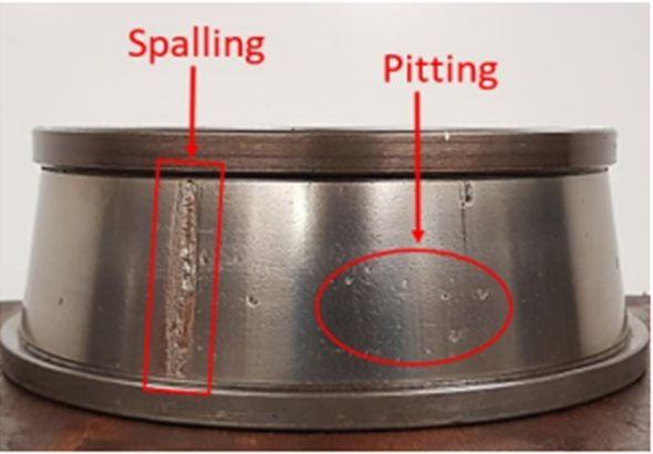 Freight bearing cup showing spalling and pitting on the raceway surface