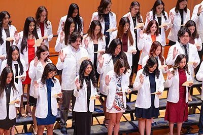rows of newly graduates with doctor coats on