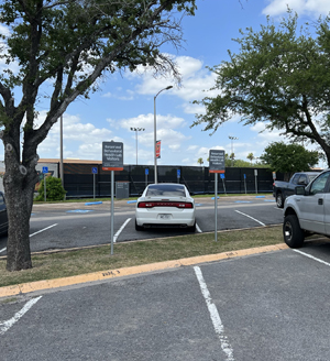 Reserved parking spaces in the second row, closest to tennis courts