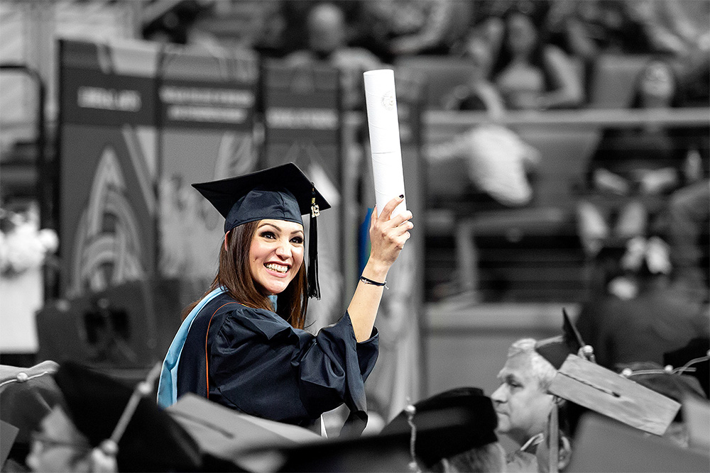 Girl holding her diploma at graduation ceremony