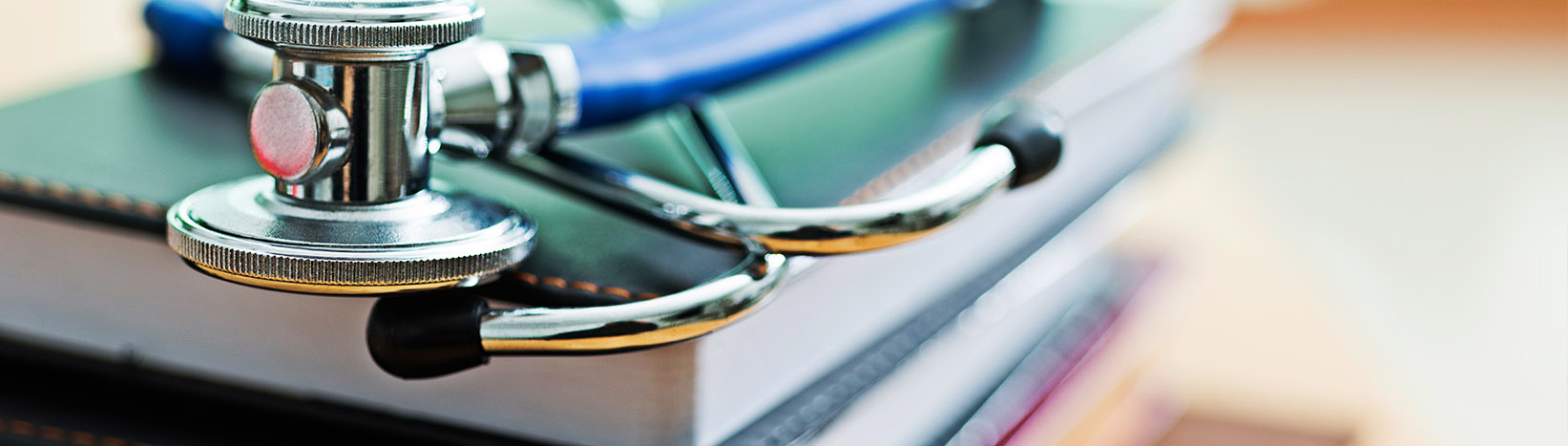 Medical stethoscope on top of books