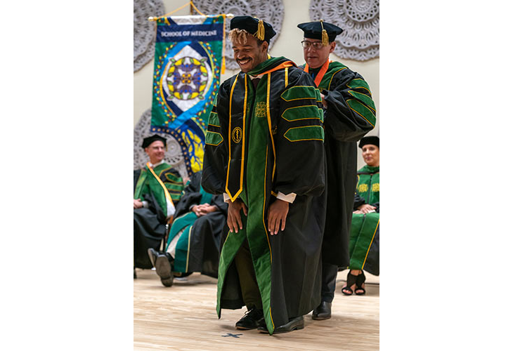 Dr. Leonel Vela, Senior Associate Dean for Education Resources, Chief Physician for Community Health Partnerships and Outreach, and Chair, Department of Population Health and Biostatistics, hooding Rebisi Anthony Owhonda. Page Banner 