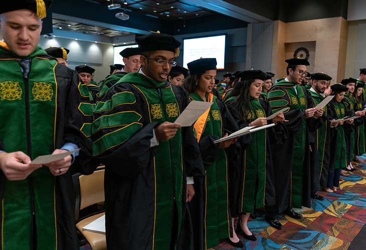 School of Medicine Class of 2022 students reciting the Physician’s Oath, led by their classmate, Adaeze Stephanie Onyechi. Page Banner 
