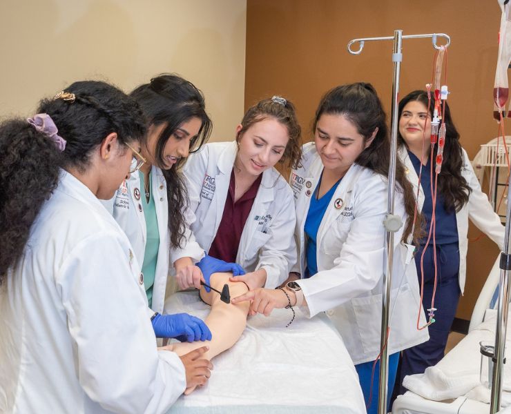 SOPM students assisting patient.