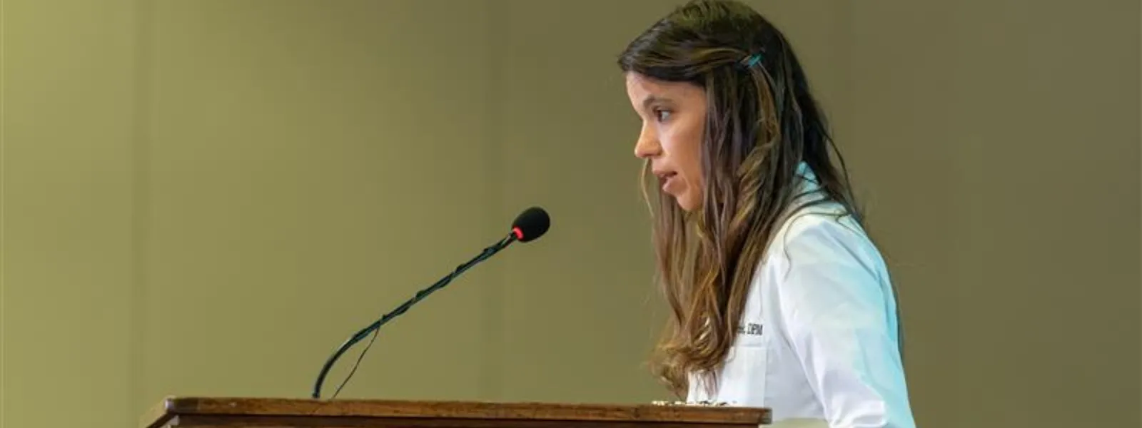 Faculty member speaking at a podium.