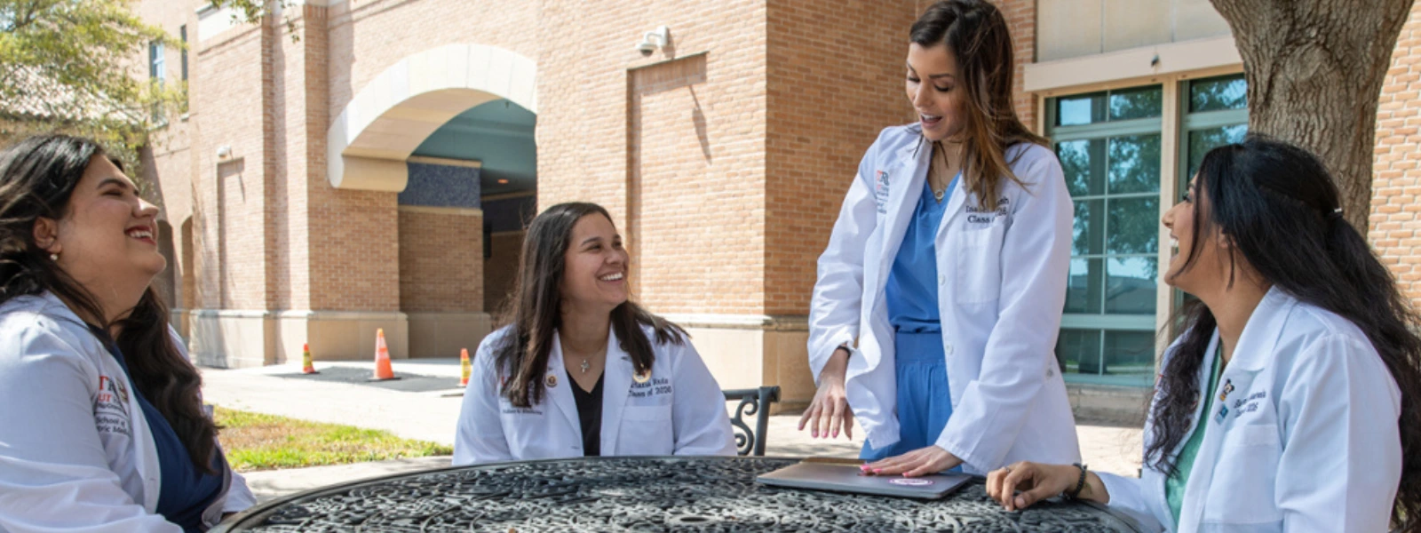 SOPM students sitting outdoors.