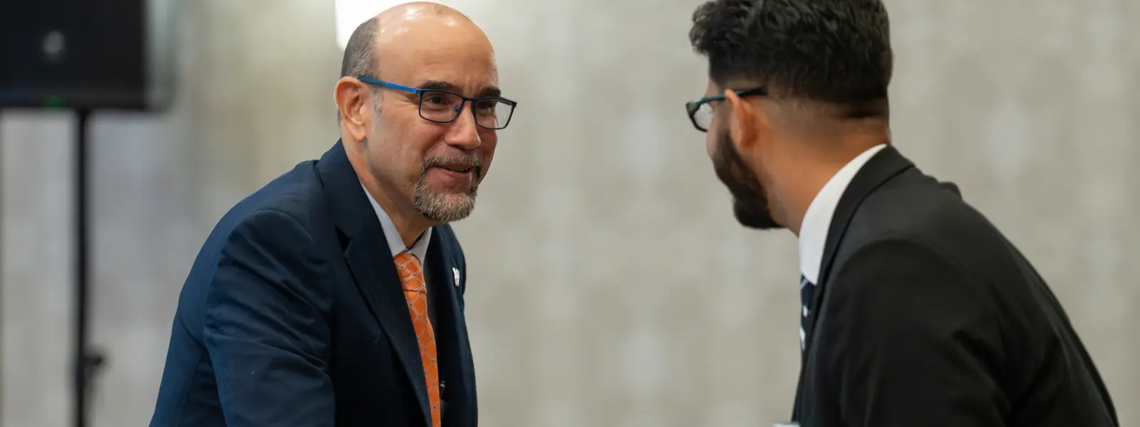 Dean shaking hands with student.