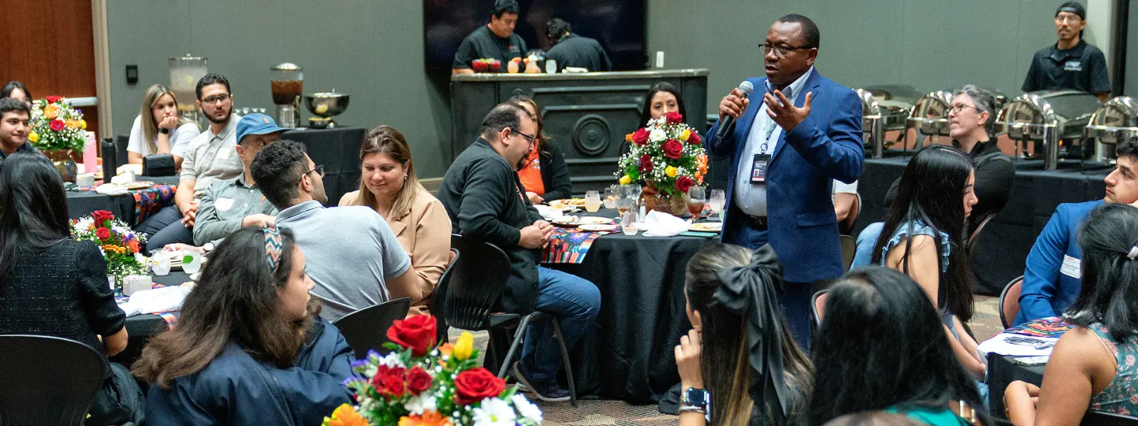 Faculty speaking to students during ceremony.