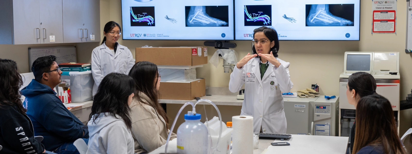 SOPM faculty teaching a high school class during summer.