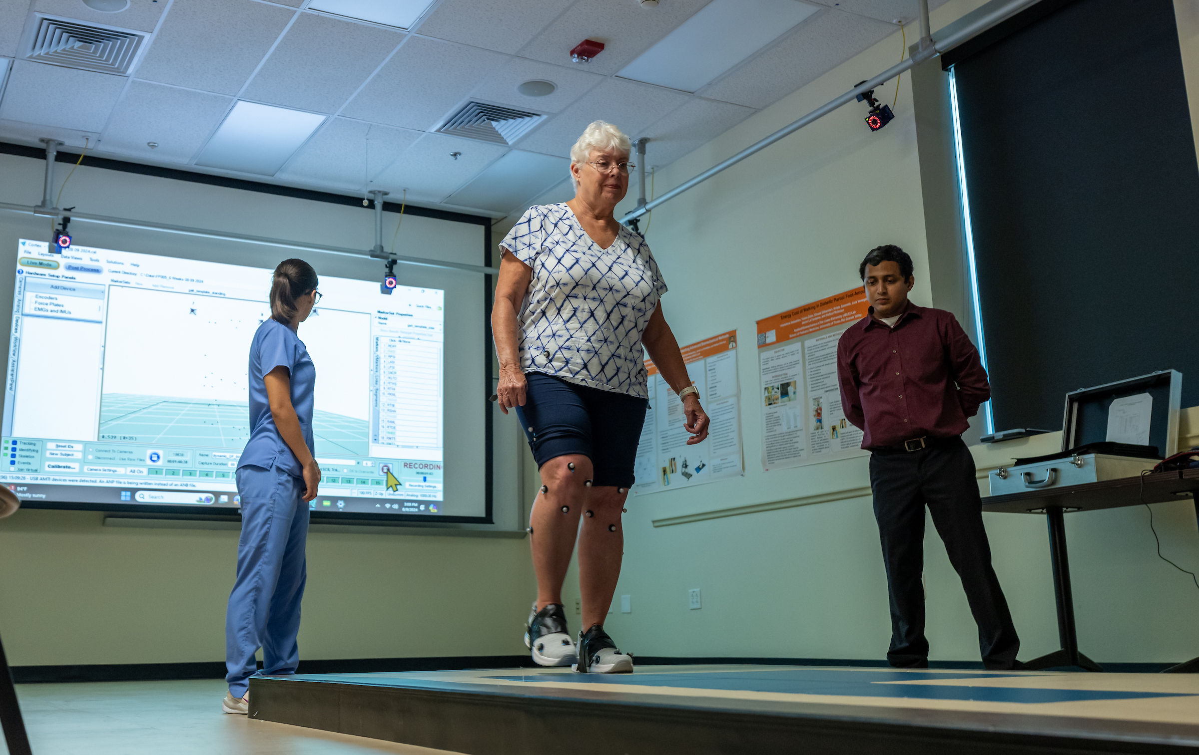 SOPM faculty member watching patient walk.