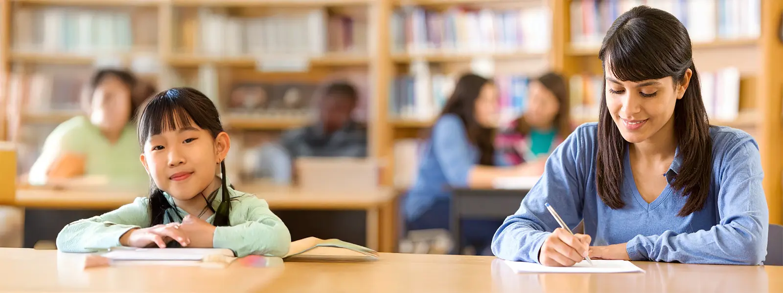 student and child at the library