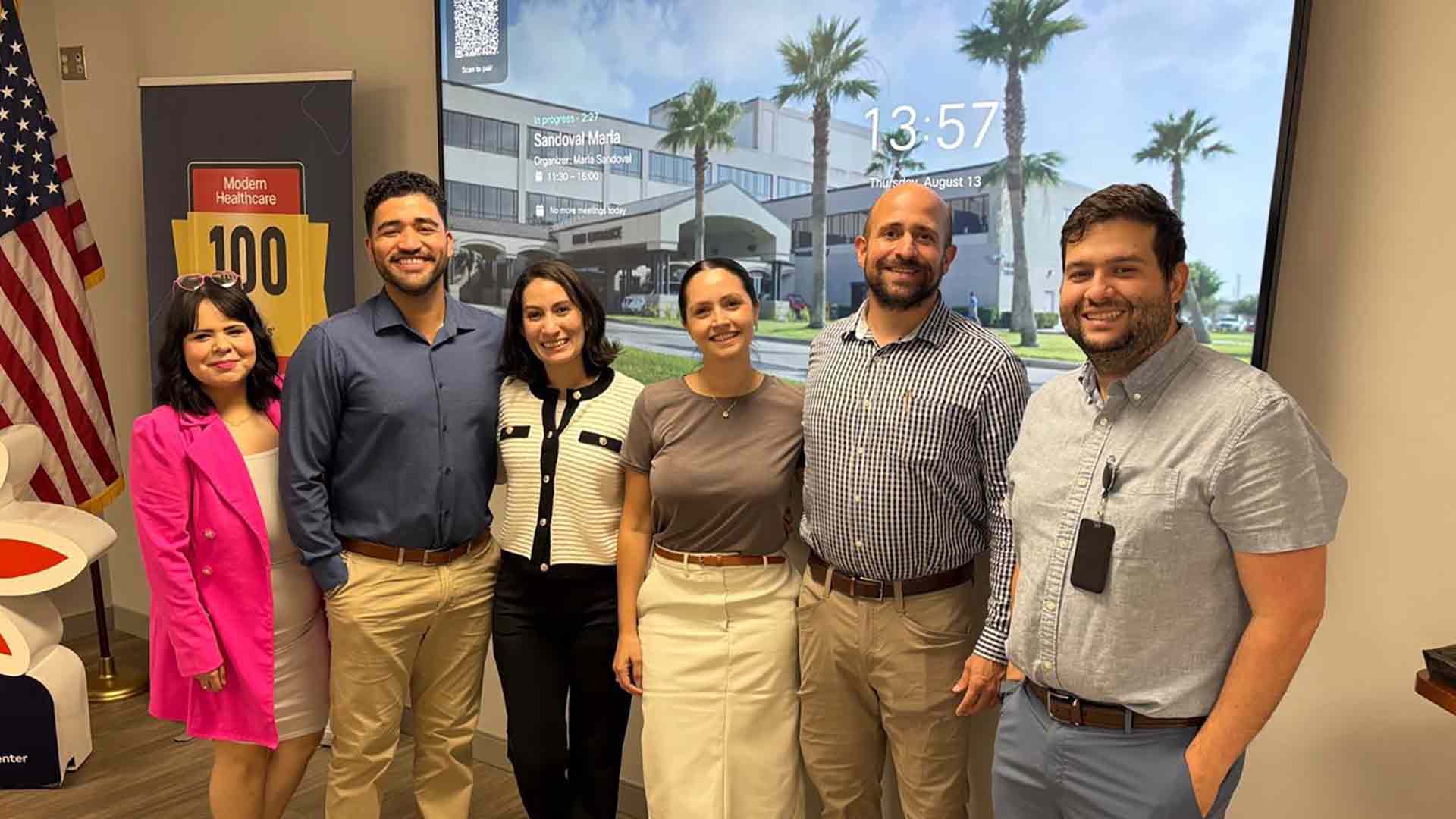 UTRGV physicians and residents gather for a group portrait during a visit to a healthcare facility.