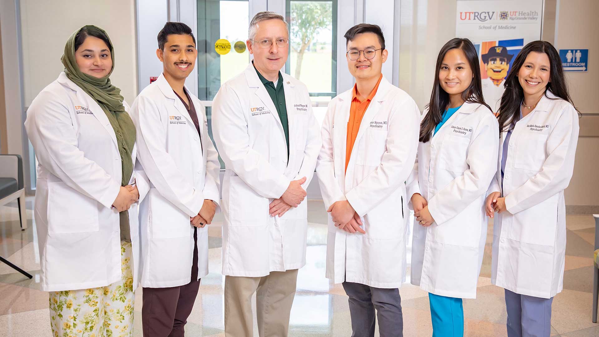 A group shot of six medical professionals in white coats