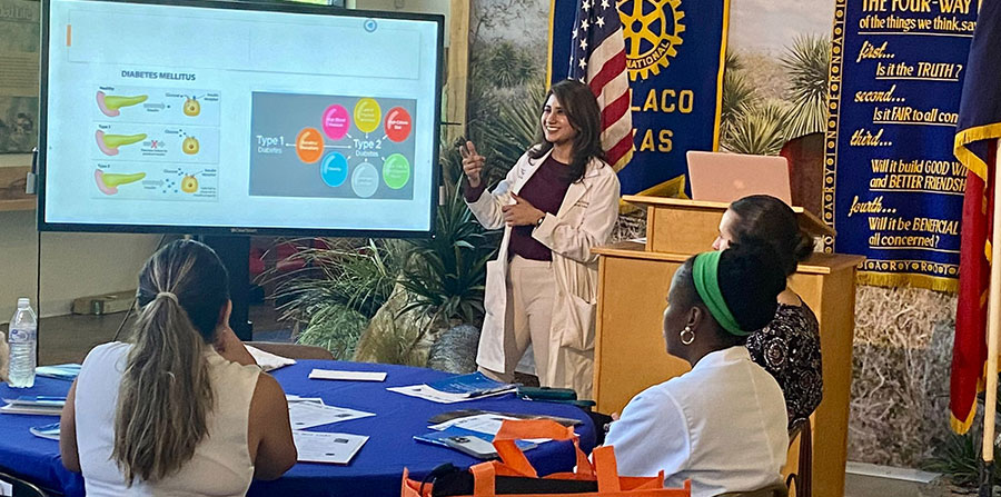 Dr. Akhtar giving an oral presentation at the Rotary Club.