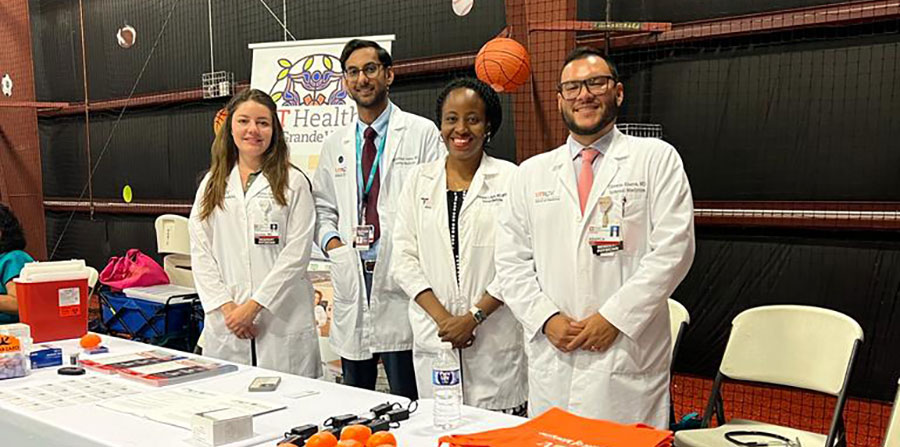 Dr. Escobar, Dr. Jamal, Dr. Bello, and Dr. Abarca serving the community at a health fair.