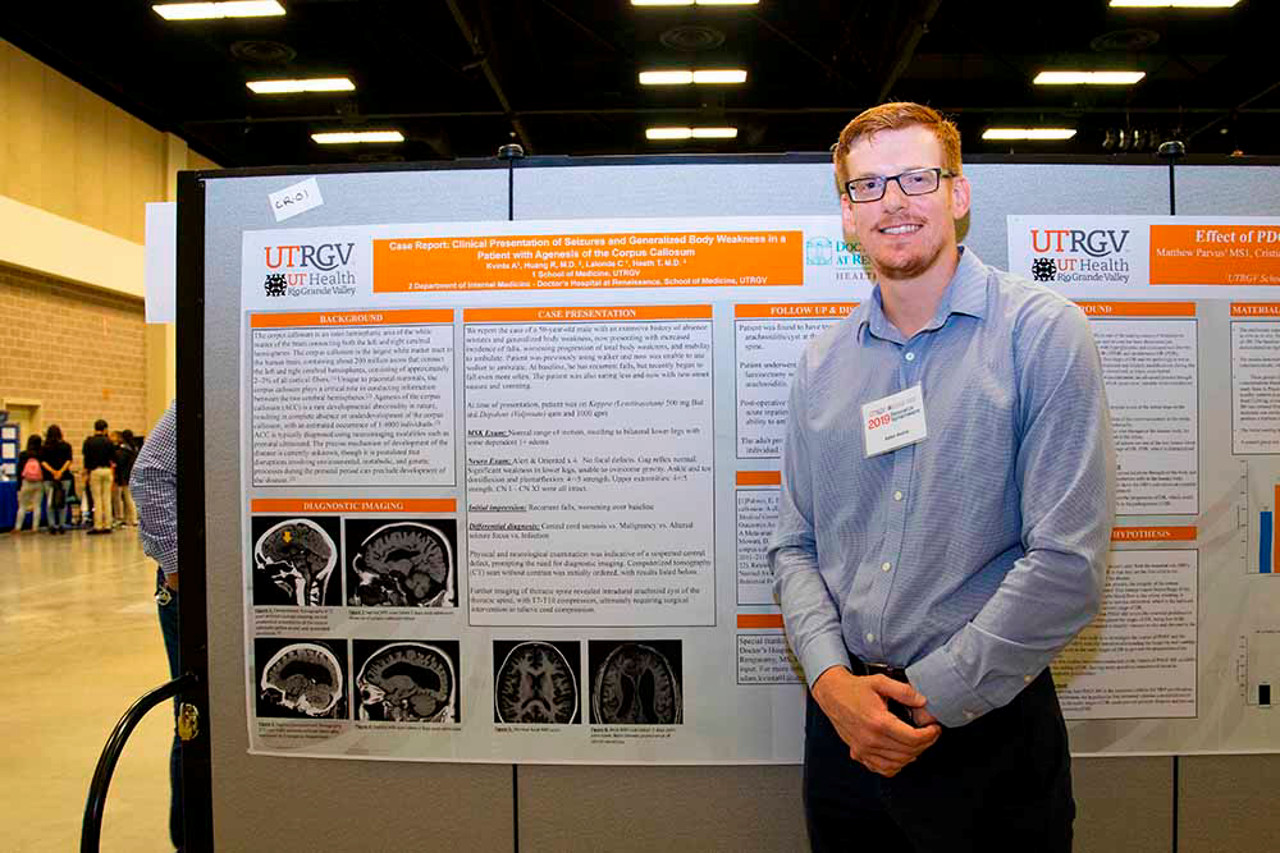 Person in front of Research Poster