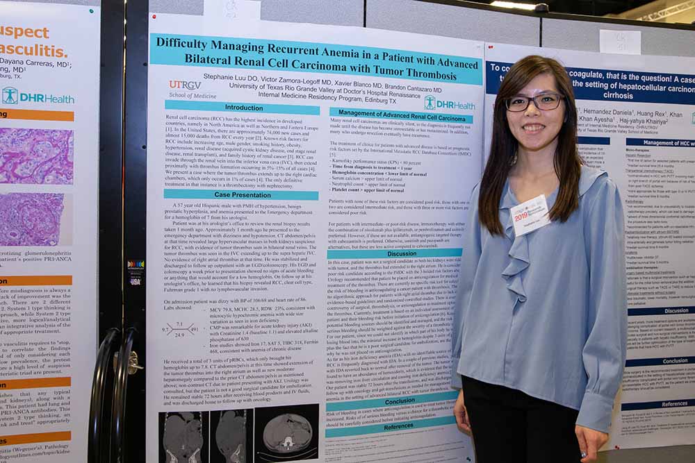 Person In front of Symposium Poster