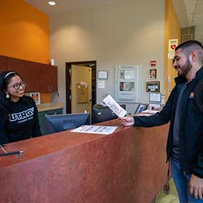 front desk staff helping student