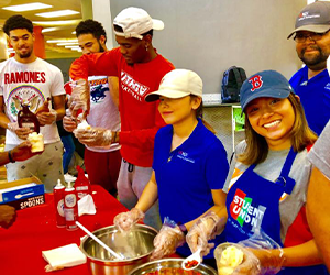 group of students and student athletes serving ice cream in the union commons