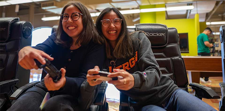 two students playing video games at the Student Union