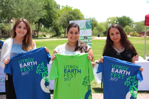 3 girls holding 3 different earth fest 2017 STIAC shirts at the 2017 UTRGV Earth Day event