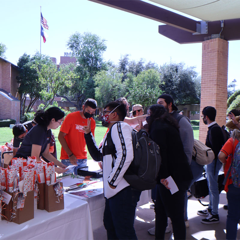 Students surrounding the tables set up by the Office for Sustainability on Campus Sustainability Day on the Edinburg Campus by the Student Union