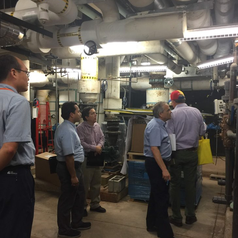 picture of demand response participants looking at pipes