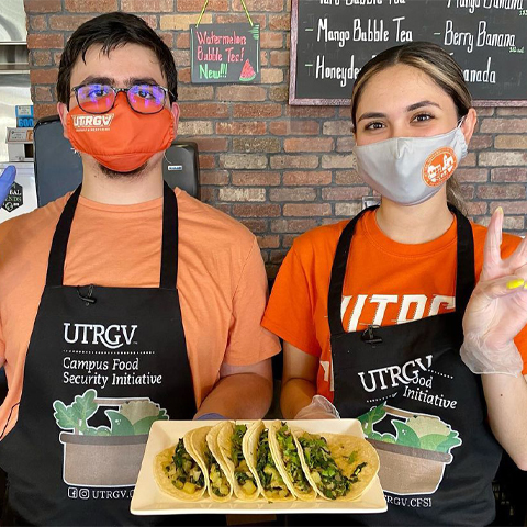 a picture of two students that are a part of UTRGV's campus food security initiative who hosted a food recipe webinar showing the results of their webinar which were spinach and potato tacos