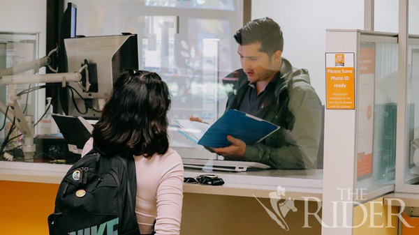 Hiram Martinez, a UTRGV enrollment generalist, explains financial aid requirements to art freshman Andi Provincia last Wednesday at the Financial Aid Office on the Brownsville campus. The UTRGV Tuition Advantage grant will launch in Fall 2022 and will cover the cost of tuition and mandatory fees for students with a family income of $100,000 or less who have unmet financial need. Luis Martinez Santillano/The Rider Photos